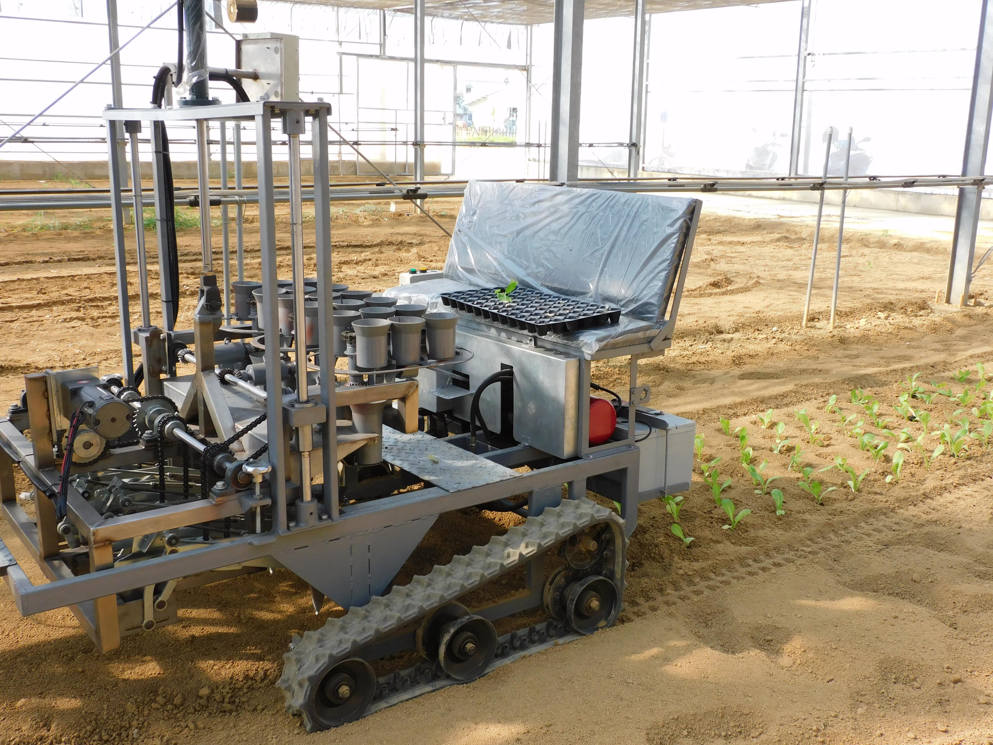 Fig. 1 The electric crawler-type vegetable transplanter operates in the greenhouse without engine exhaust or noise issues